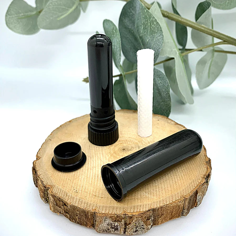 Unscented black aroma stick with cap off, showing cotton wick.