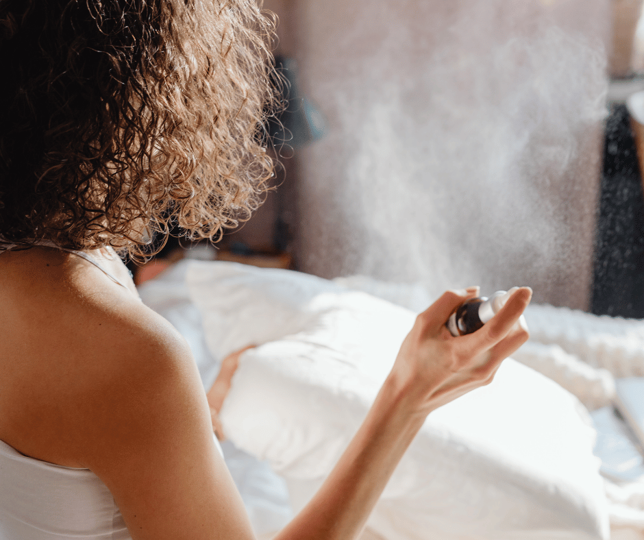 Spraying Rose Water floral mist onto pillow for relaxation.